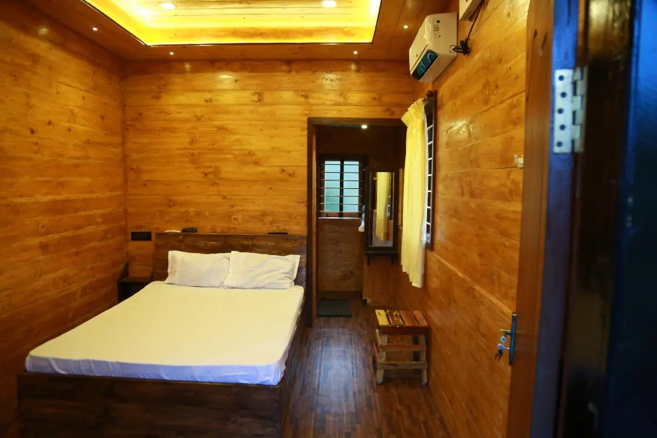 Lily room — teak-lined AC bedroom with air conditioning and attached bathroom