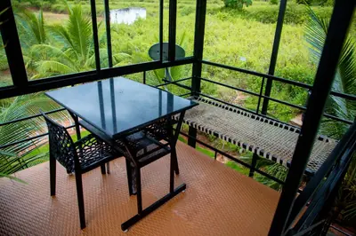 Terrace table and chairs under the green roof with a valley view