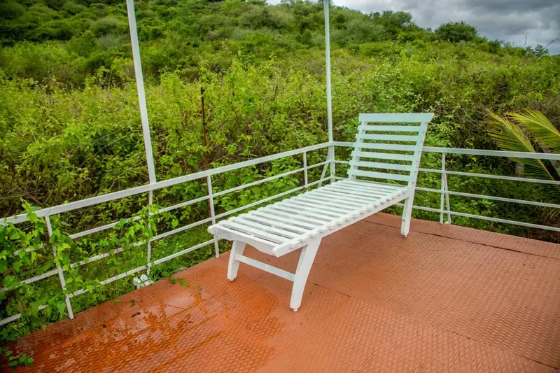 White bench on the terrace looking out over the green valley