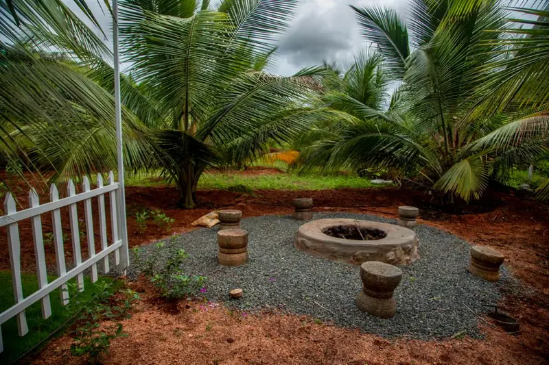 Campfire pit with stone seating set among the coconut palms